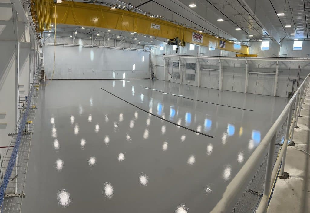 Image of an industrial resinous flooring installation, with a seamless and glossy finish that is both beautiful and durable.