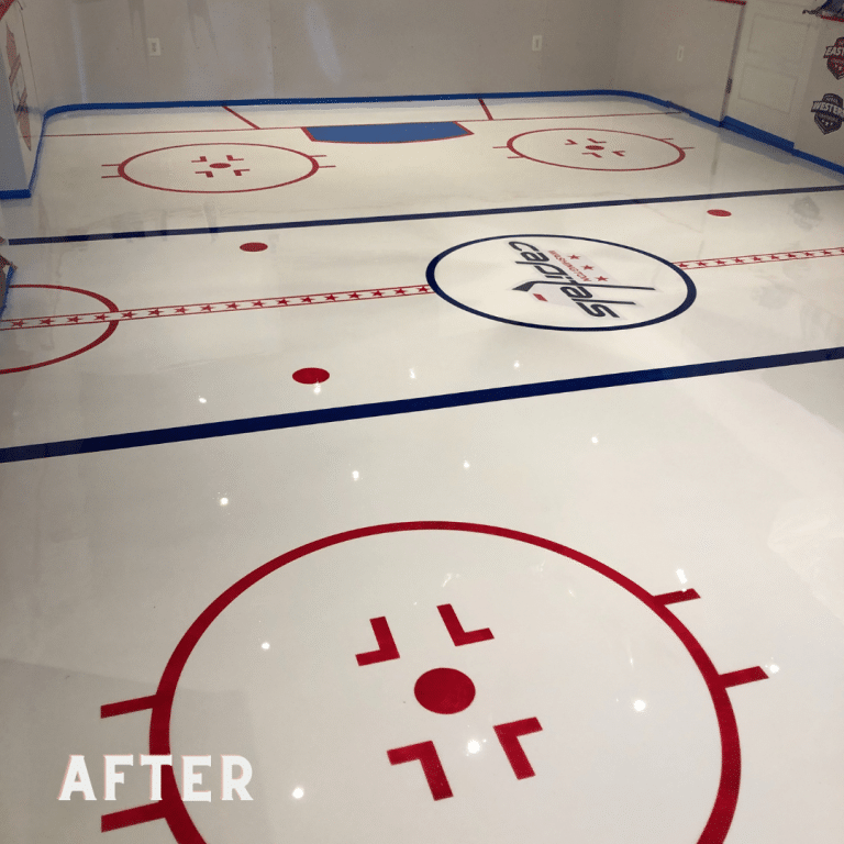 Image of a resinous epoxy flooring in shades of gray with a company logo embedded in the center. The flooring has a glossy finish and a smooth surface with natural variations in color.